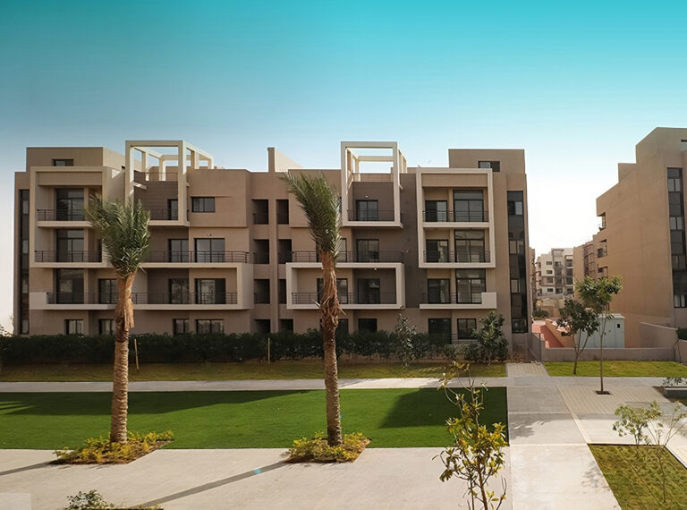 Apartment block facing a central lawn with palms at 5th Square, Fifth Settlement