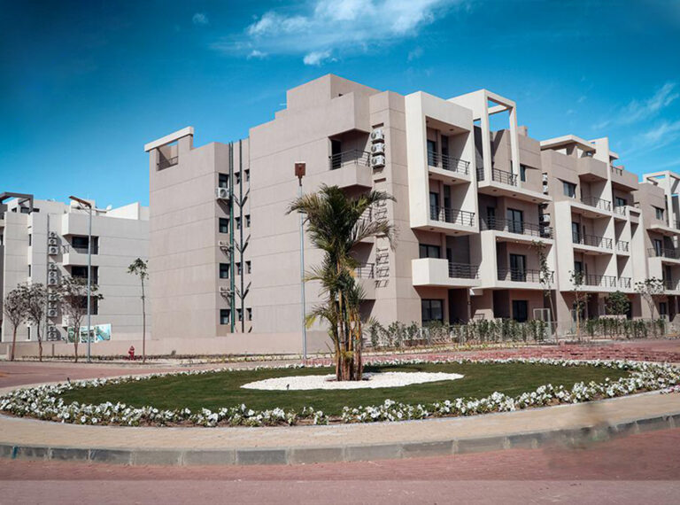 Apartment buildings around a landscaped green with a fountain at 5th Square, Fifth Settlement
