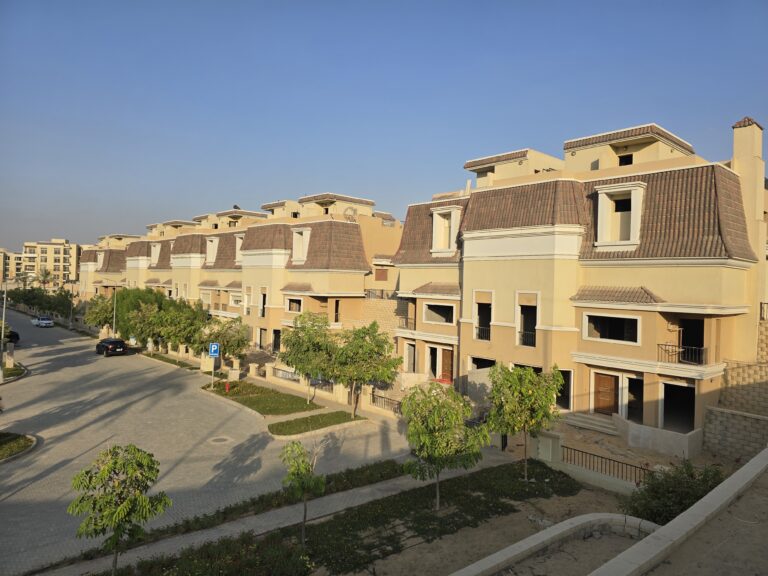 Corner townhouses with young trees and landscaped verges at Sarai, New Cairo