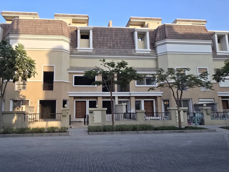 Townhouse facade with tiled roof and balconies at Sarai, New Cairo