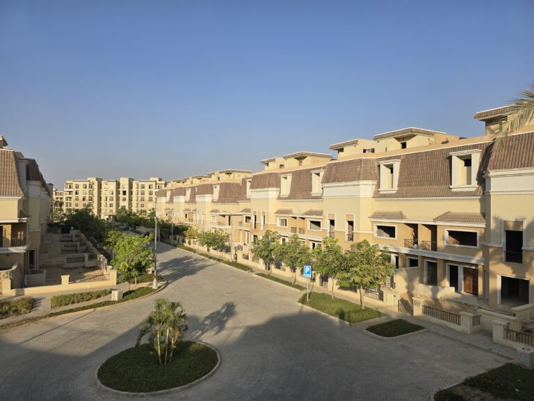 Townhouse street with a landscaped island at Sarai, New Cairo