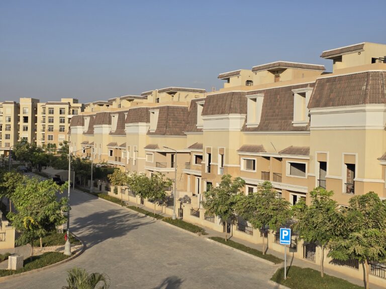 Townhouse row with tiled roofs seen along the street at Sarai, New Cairo