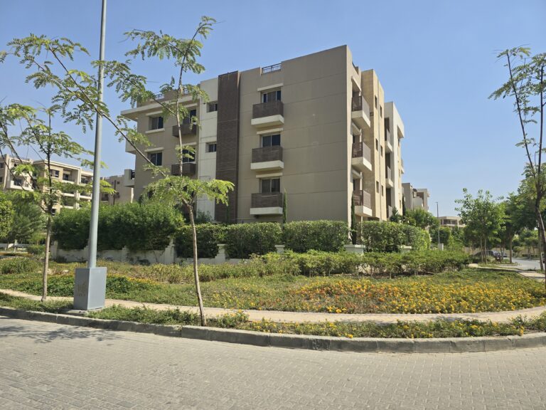 عمارات سكنية منخفضة الارتفاع بجوار ميدان بمساحات خضراء في كمبوند تاج سيتي، القاهرة الجديدة